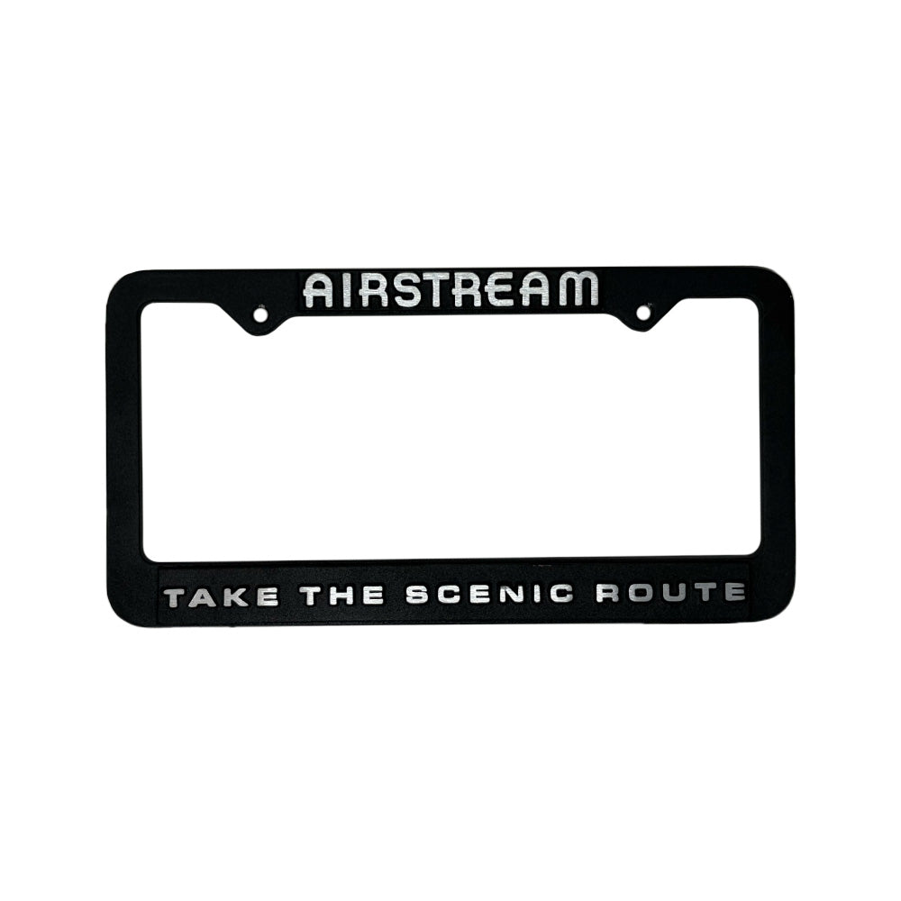 Black license plate frame with 'Airstream' and 'Take the Scenic Route' text on a white background
