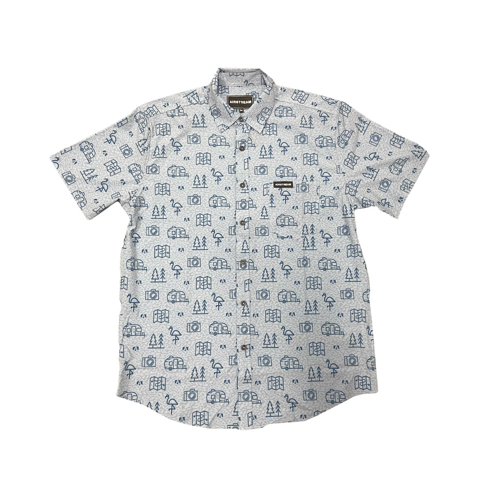 The Airstream Conversational Button Down Shirt is a short-sleeve, lightweight button-down featuring a white background adorned with blue outdoor-themed illustrations—trees, tents, and mountains. Designed for summer adventures, it includes a convenient front pocket on the left side, making it perfect for your next getaway.