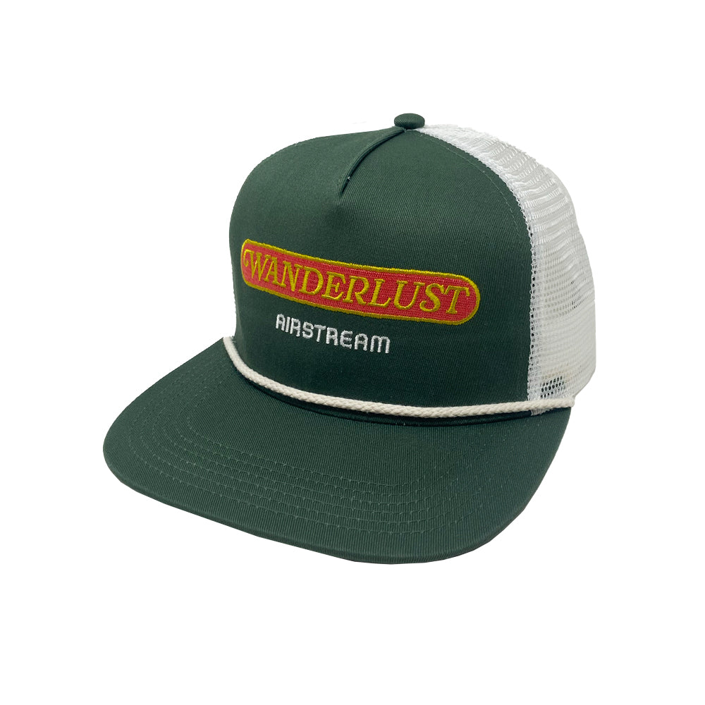 Introducing the Airstream Wanderlust Trucker Hat—a green and white mesh-back cap featuring a yellow and red patch that reads “WANDERLUST” and white “AIRSTREAM” text on the front panel. With an adjustable snapback closure, it offers a comfortable, custom fit.