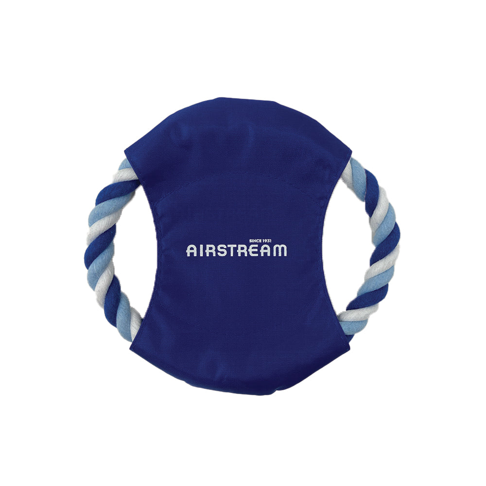 The Airstream Fetch-It Dog Toy features a blue and white rope forming a circle around a blue fabric center, which is printed with the word “AIRSTREAM” in white letters. This durable dog toy is perfect for outdoor play or as a fun fetch toy.
