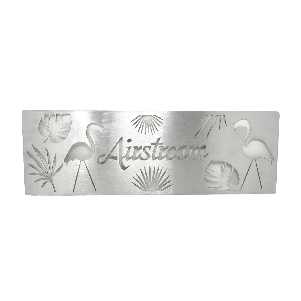 Introducing the Airstream Flamingo Screen Door Guard—a rectangular metal plaque featuring cutout designs of flamingos, tropical leaves, and the word “Airstream” in cursive at the center. Perfect for adding a custom touch to your screen door.