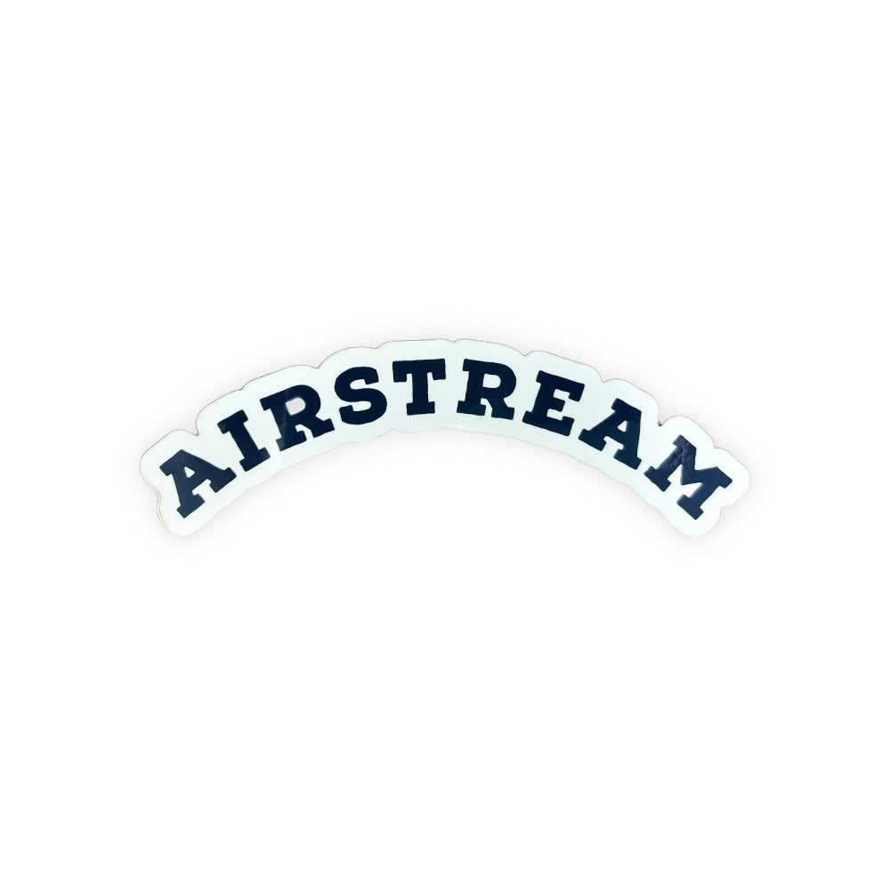 The Airstream Heritage Arc Sticker features the word AIRSTREAM in bold, black, uppercase letters curved upward on a white background, making it a perfect addition to your travel gear or collection of vintage decals.
