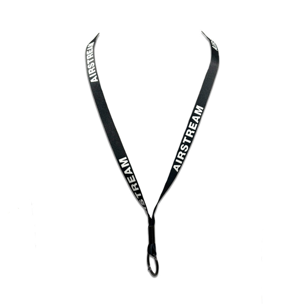 Airstream Logo Lanyard displayed against a white background, featuring “AIRSTREAM” printed in white on both sides of the black strap, and finished with a black clip at the bottom for attaching keys or ID badges—ideal for any Airstream enthusiast.