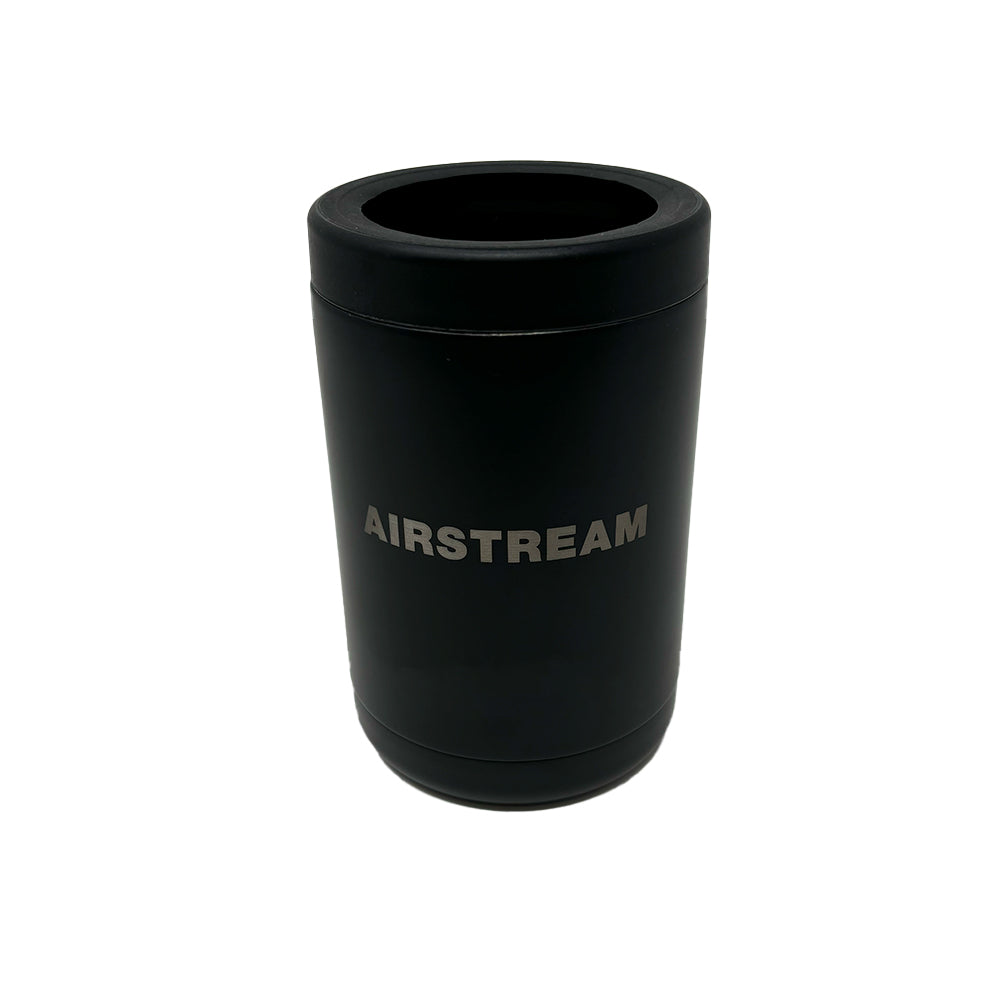 Airstream Metal Can Holder: This black, cylindrical insulated can holder features the word “AIRSTREAM” printed in bold silver letters on the front. Set against a plain white background, this sleek accessory ensures your beverage stays cold in style.