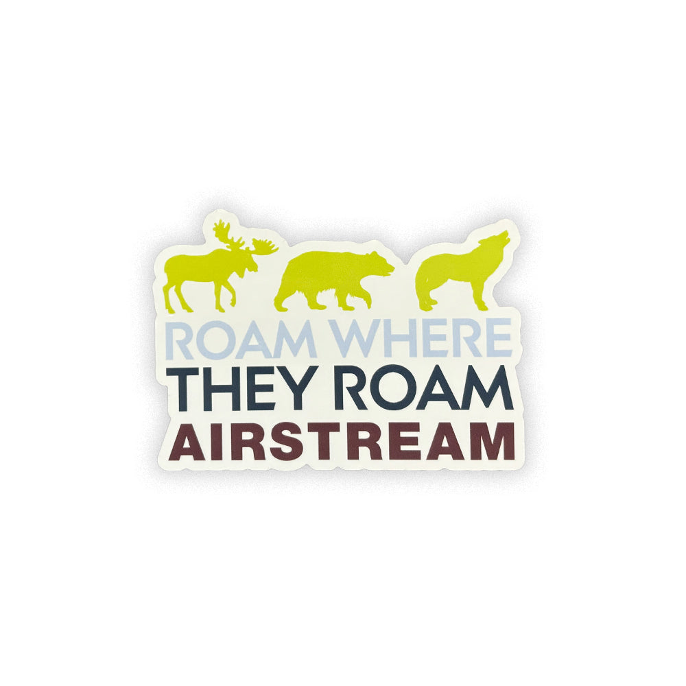 The Airstream Roam Where They Roam Sticker showcases silhouettes of a moose, bear, and wolf above the phrase “ROAM WHERE THEY ROAM AIRSTREAM” on a crisp white background—an ideal addition to your adventure decal collection.