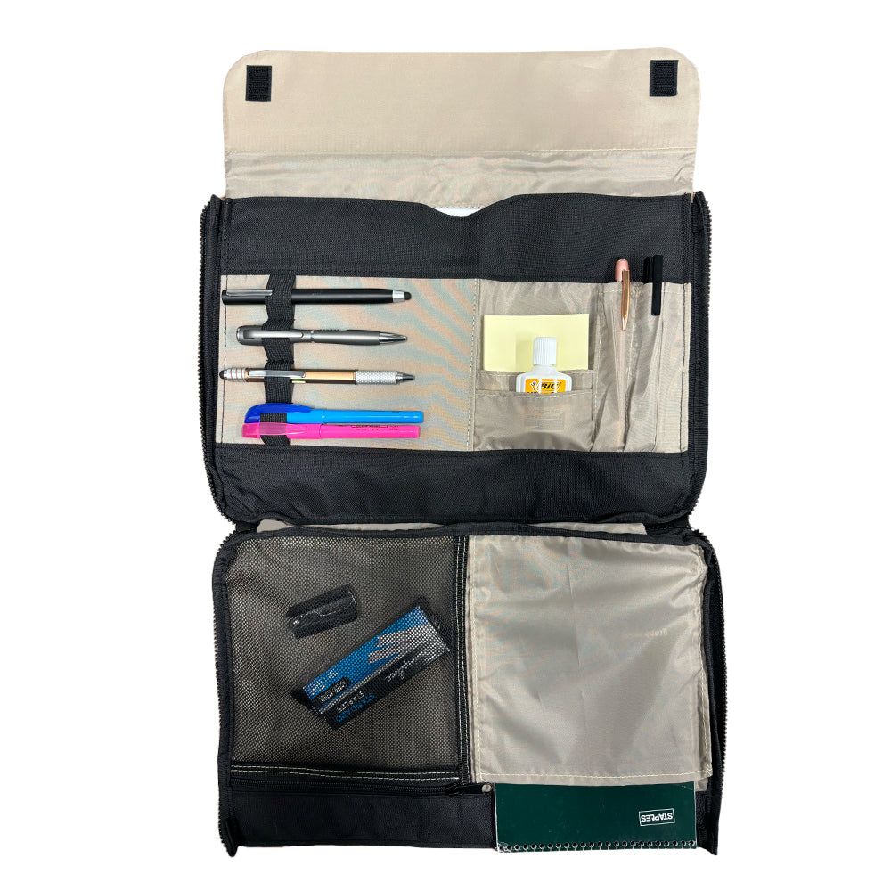 An open black organizer pouch displays pens, pencils, sticky notes, glue, correction tape, and a green notebook in neatly arranged compartments and mesh pockets against a white background—ideal for slipping into your Airstream Signature Series Laptop Commuter Sleeve or pairing with its padded laptop compartment for efficient and organized commuting.