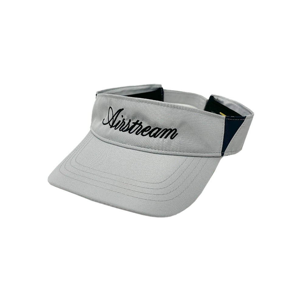 The Airstream Signature Series Visor features a light gray color with “Airstream” embroidered in black cursive on the front, providing stylish sun protection.
