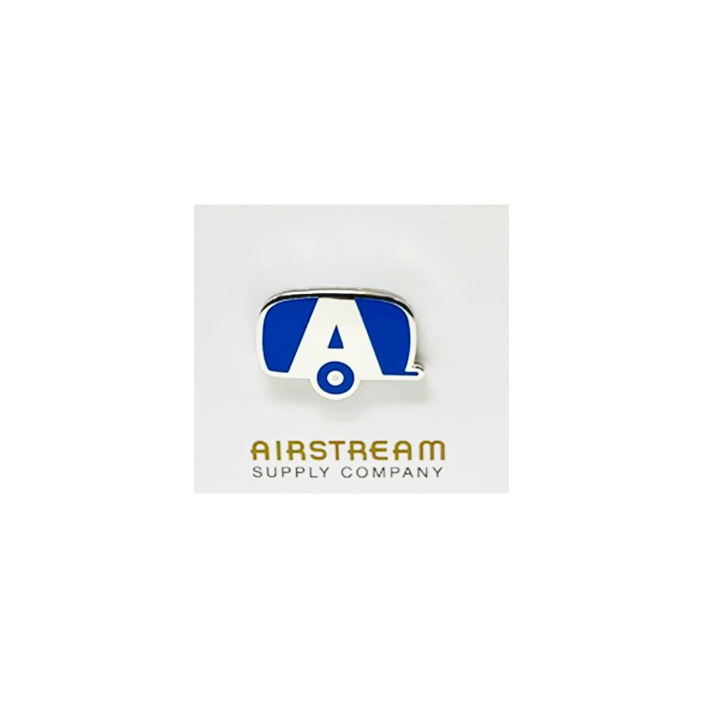 The Airstream Trailer A Logo Pin is a quirky accessory shaped like a travel trailer, featuring a blue and white design with a prominent Airstream “A” at its center. Gold text reading “Airstream Supply Company” appears below on a white background, making this logo pin the perfect collectible for travel enthusiasts.