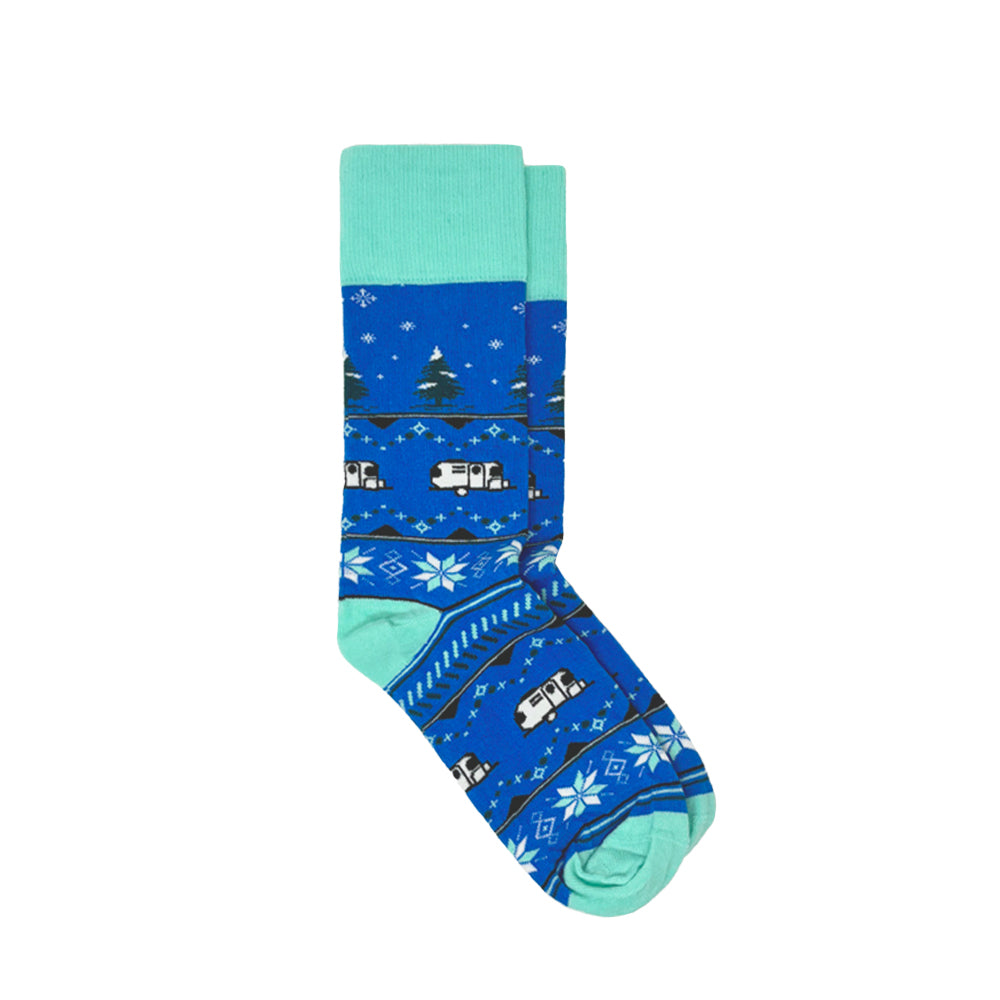 Airstream Winter Wonderland Socks: a pair of cozy blue and turquoise socks adorned with a winter pattern of snowflakes, trees, and camper vans.