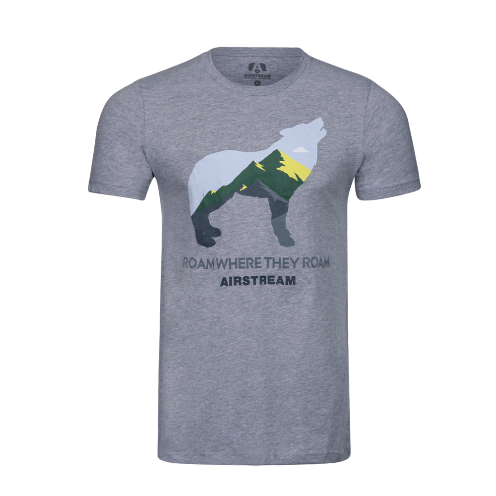 The Airstream Roam Where They Roam Wolf T-Shirt features a gray design with a graphic of a wolf silhouette filled with mountain scenery. Beneath the image, the words “ROAM WHERE THEY ROAM AIRSTREAM” are printed, making this an ideal addition to any nature shirt collection and perfect for adventure-loving fans of Airstream.