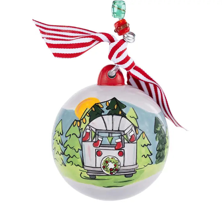 The Always Take the Scenic Route Christmas Ornament is a round decoration featuring a charming camper van, trees, and sun design that embodies both adventure and holiday cheer. Accented with a striped red and white ribbon and festive green and red beads, this ornament makes an ideal travel keepsake for those who love to celebrate memories of exploring new places during the holidays.