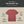 Red t-shirt with features labeled on a beige background