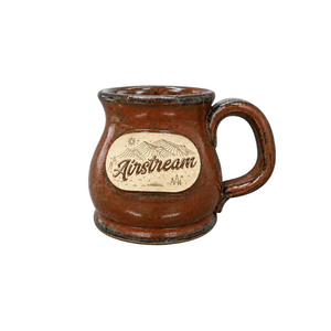 Airstream Artisan Handcrafted Pottery Mug in brown ceramic, featuring a central embossed emblem of mountain scenery.