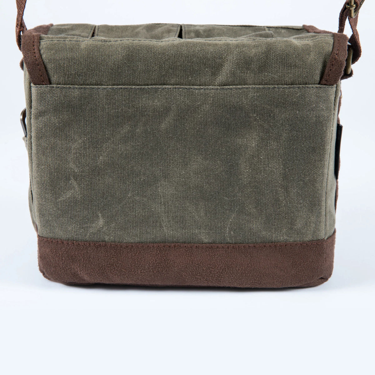 The Airstream Beer Caddy Cooler Tote is a rectangular, olive green canvas bag with brown suede-like trim, displayed from the back against a plain white background. Designed with a shoulder strap, this tote appears sturdy and functional for carrying beverages.
