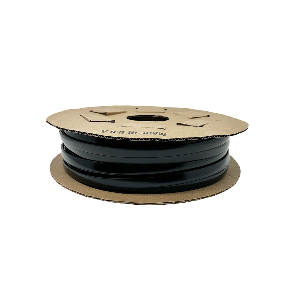 A flat, circular cardboard reel with cut-out handles holds the Airstream Premium Replacement Belt Trim for Travel Trailers. Designed as an ideal exterior accessory for your Airstream, this spool of black trim comes labeled MADE IN USA.