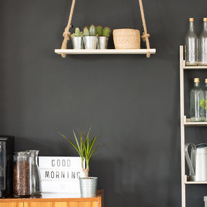 Modern kitchen with black wall, swing shelf and ladder bookcase