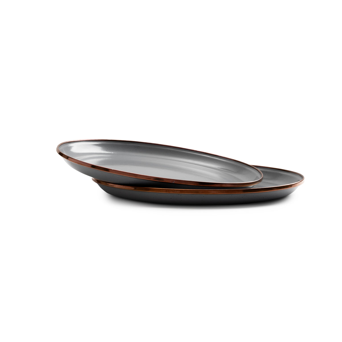 Two overlapping, oval-shaped plates from the Enamel Dining Sets by Barebones—crafted from durable enamelware with a glossy gray finish and brown rims—are stacked on a white background, making them the ideal shatterproof dinnerware choice for any Airstream galley.
