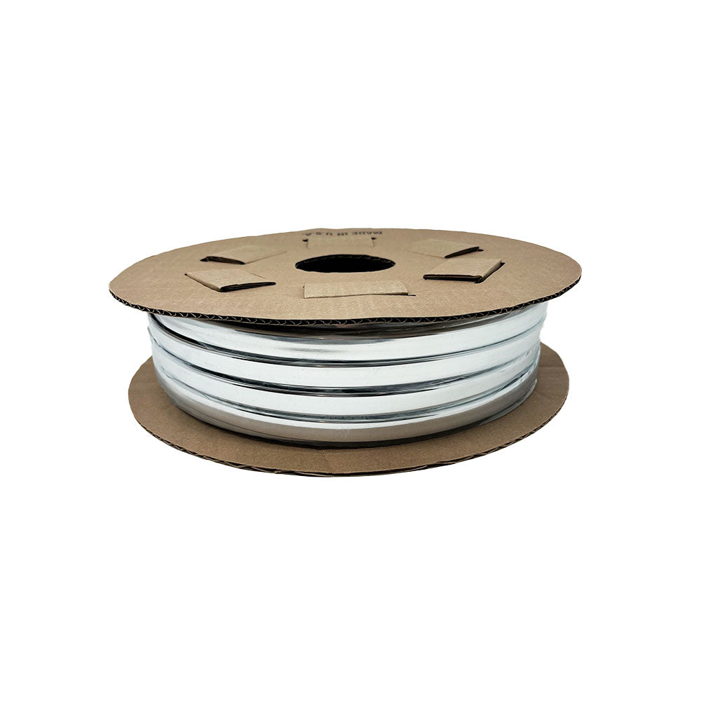 A spool of Airstream Premium Replacement Rub Rail for Travel Trailers is wound around a round brown cardboard reel and shown against a plain white background—ideal for restoring your riveted aluminum Airstream.