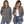 Two women wear the Airstream Women’s Long Sleeve Twill Overshirt in gray, featuring chest pockets. One has her shirt buttoned, while the other styles hers open over a white top. Both are smiling with their hands in their pockets and wear blue jeans.