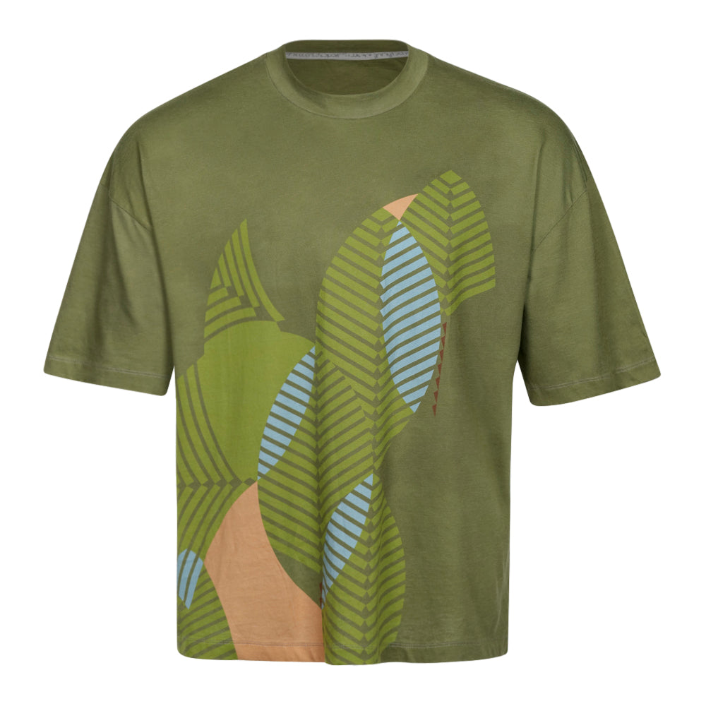 The Frank Lloyd Wright x Airstream Oversized T-Shirt features an olive green short-sleeve design with an abstract leaf pattern in green, blue, and tan on the front; its oversized fit seamlessly marries comfort and style, making it ideal for anyone who appreciates a bold architectural graphic t-shirt aesthetic.