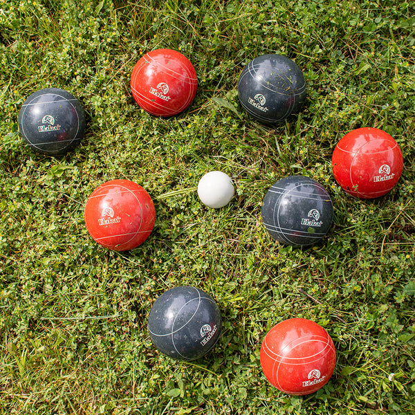 Red And Navy Elakai Bocce Balls In The Grass