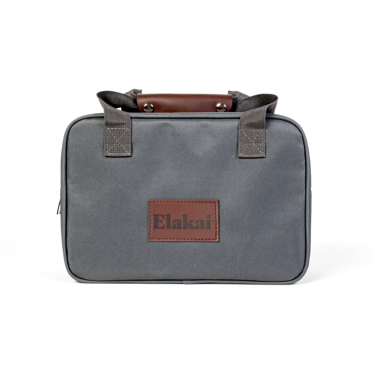 A gray rectangular canvas bag designed for the Elakai Giant Wood Dice, featuring dual handles, brown leather accents, and an Elakai patch on the front. The minimalist design makes it perfect for transporting your wooden yard dice to outdoor game nights.