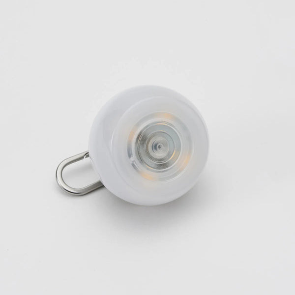 White light bulb with a metal clip on a light gray background