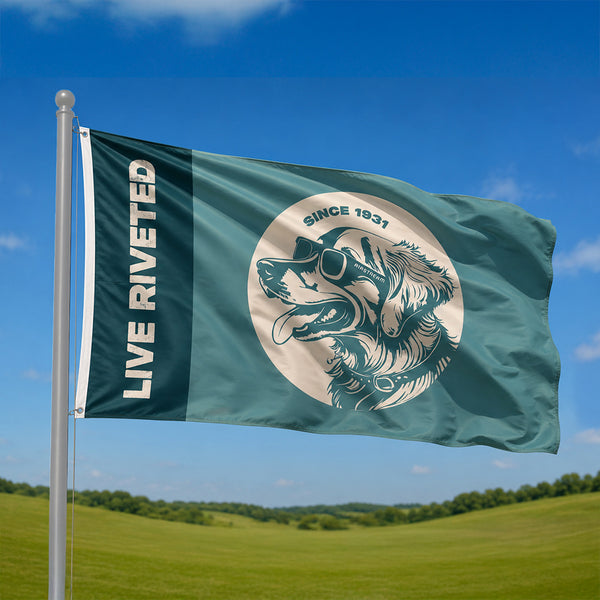 Green flag with a logo and 'Live Riveted' text against a blue sky and green field background