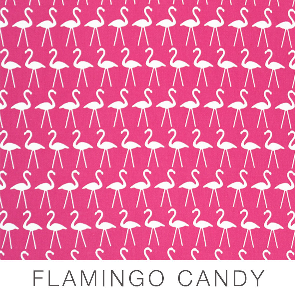 A pattern of white flamingo silhouettes on a pink background, with the words FLAMINGO CANDY written below in large capital letters—perfect for adding a playful touch to Placemats.