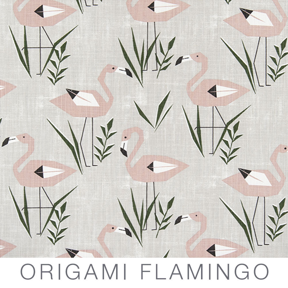 Stylized pink origami flamingos with green reeds on a light textured background evoke the playful charm of travel trailer curtains. The words “Airstream Printed Custom Curtains for Pan America Travel Trailers” appear at the bottom of the image.