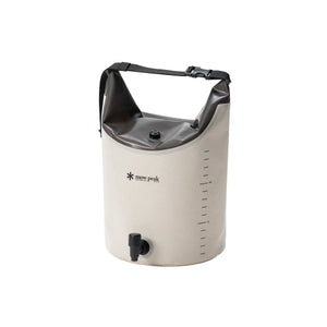 A Snow Peak dry bag cooler in off-white and black, featuring a roll-top design with a black carrying strap, a black spill valve, and printed measurement markings on the side.