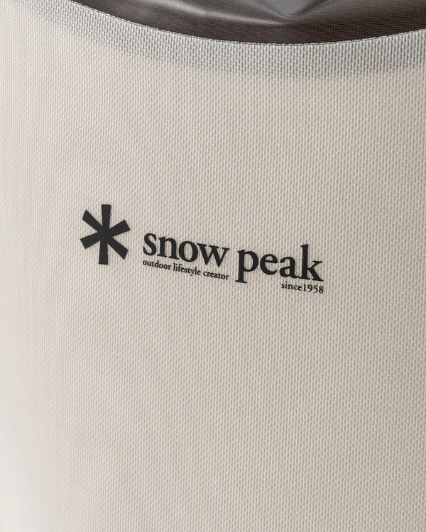 Snow Peak logo on a beige background