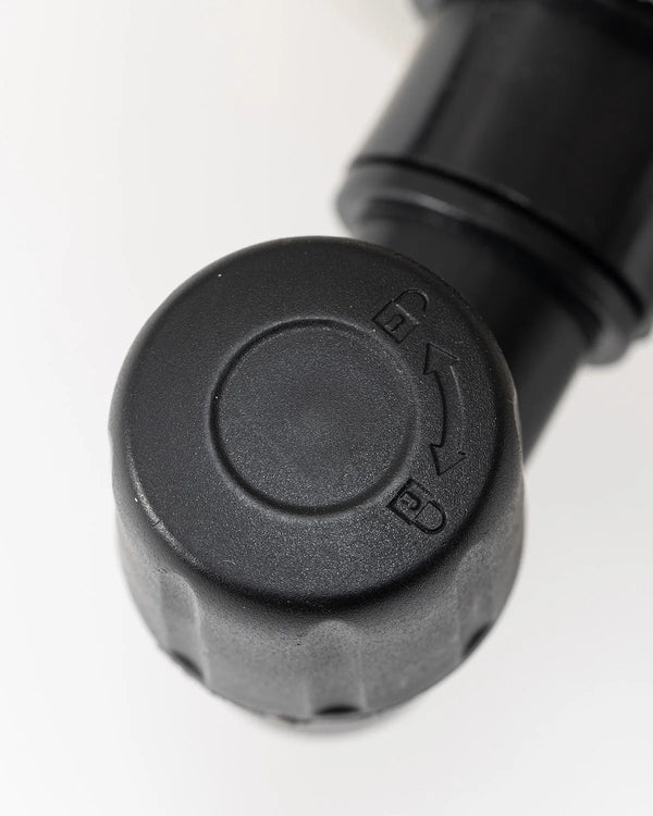 Close-up of a black plastic component with 'EV' branding on a white background