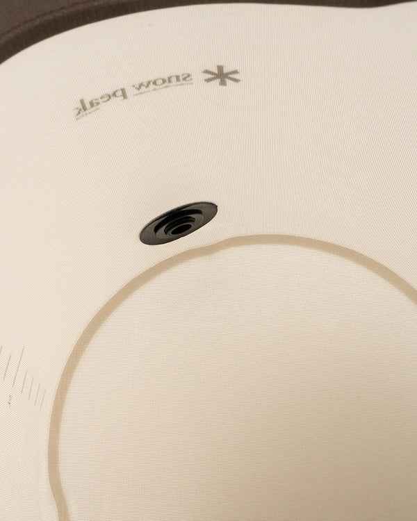 Close-up of a white snowboard boot liner with the 'snow boot' logo printed near the top and a circular ventilation hole in the center.