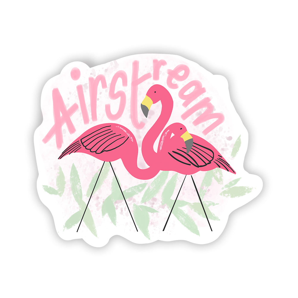 The Airstream Flamingo Flock Sticker features two pink flamingos standing together in front of the word “Airstream” written in pink, with green leaves in the background—making it a charming decal perfect for decorating your camper or adding a fun touch to your Airstream.