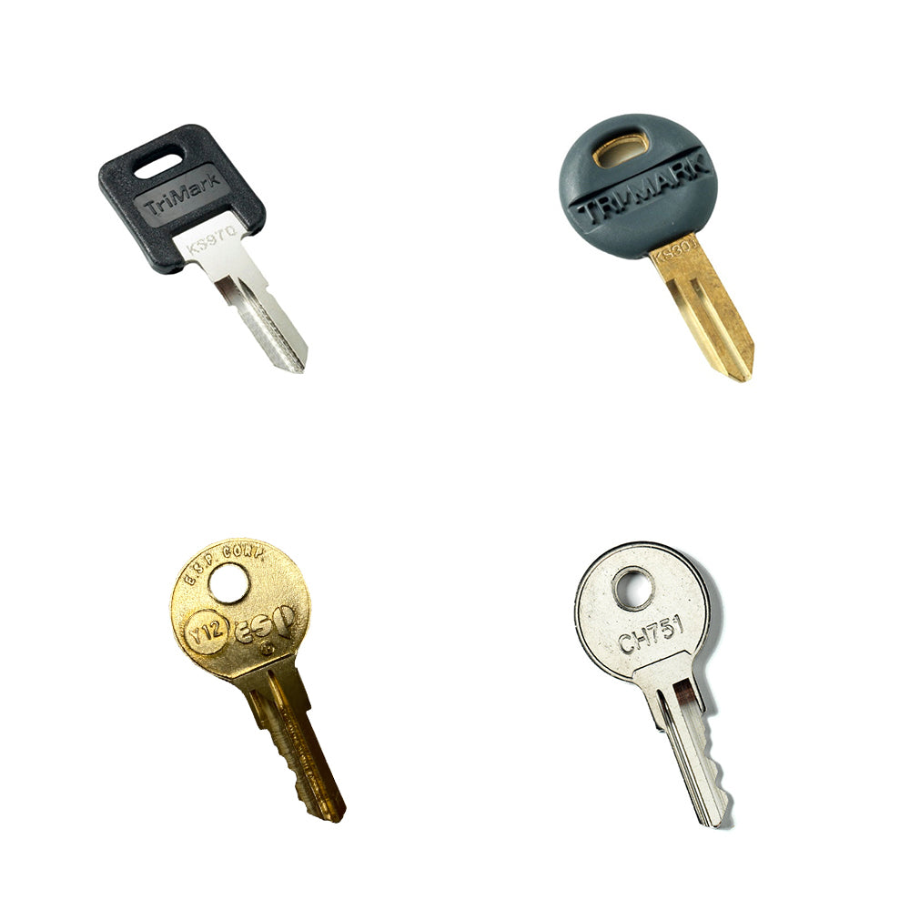 Four pre-cut keys from the Airstream Cut Key Bundle for Flying Cloud Travel Trailers are arranged against a white background. Each key features a unique shape, color, and head design, with various labels and engravings visible on the metal and plastic parts—making them ideal as spare keys or specifically as replacements for Airstream Flying Cloud models.