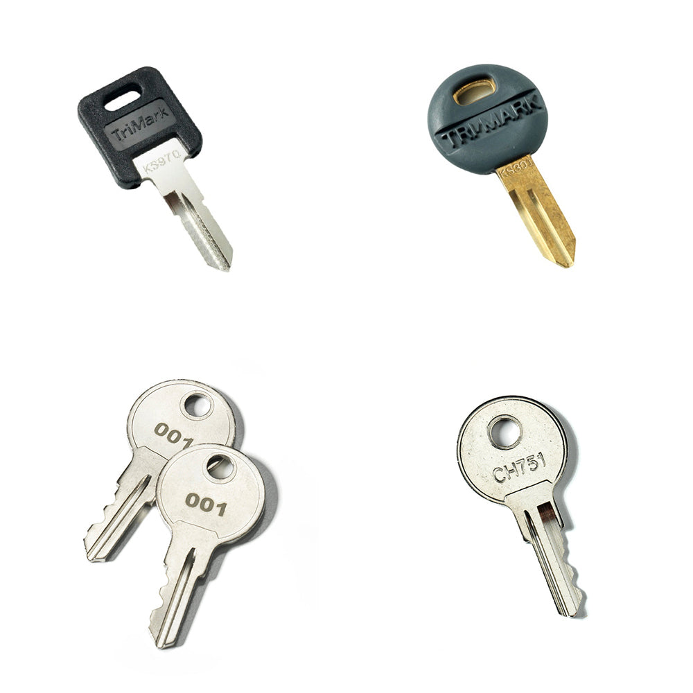 Four pre-cut keys from the Airstream Cut Key Bundle for Pottery Barn Travel Trailers are displayed on a white background: two with black plastic heads, and two plain metal keys labeled 001 and CH751. This versatile set provides ideal solutions as travel trailer spare keys or as replacements for your Airstream Pottery Barn entry needs.