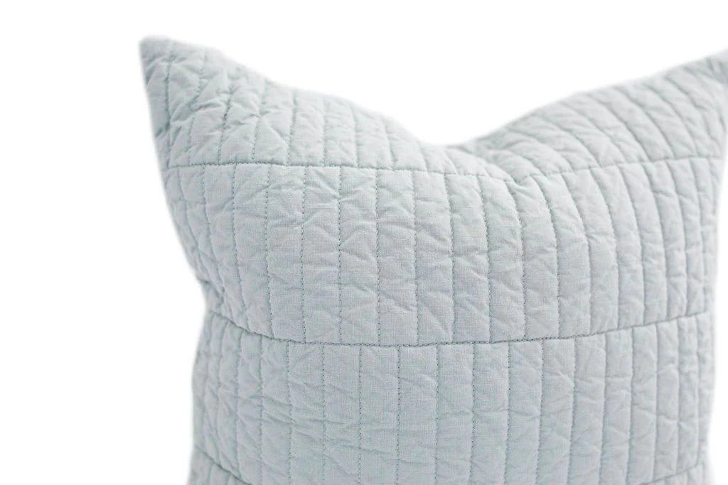 A close-up of the Harper Medium Pillow Cover by Beddy’s, featuring a light gray quilted design with a grid pattern, set against a white background.
