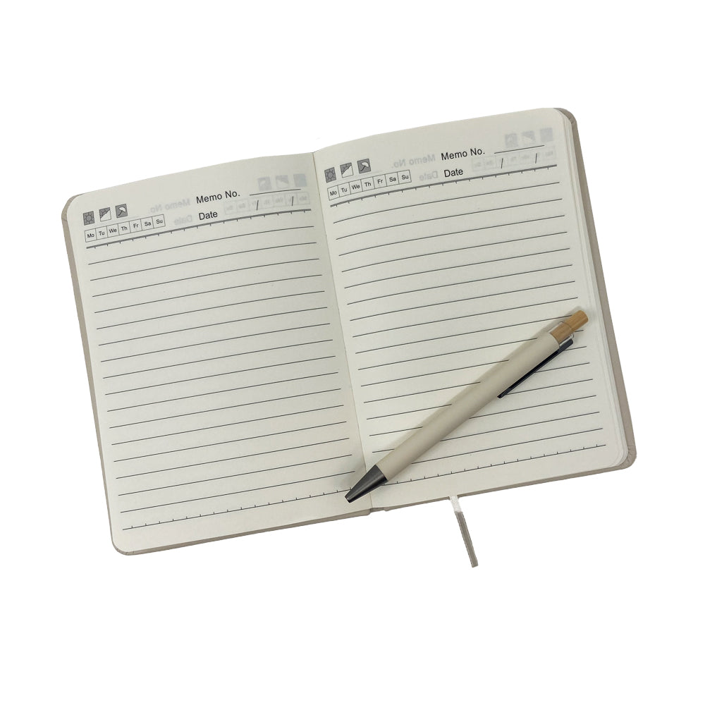 An open Airstream Horizons Journal and Pen Set featuring lined pages with a memo section and dates at the top of each page, with the included beige pen resting diagonally across the right page.