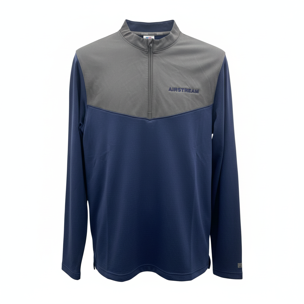 The Airstream Grid 1/4 Zip Pullover is a long-sleeve, quarter-zip top featuring a gray upper section and navy blue lower section, crafted from soft grid fleece with the AIRSTREAM logo on the left chest.