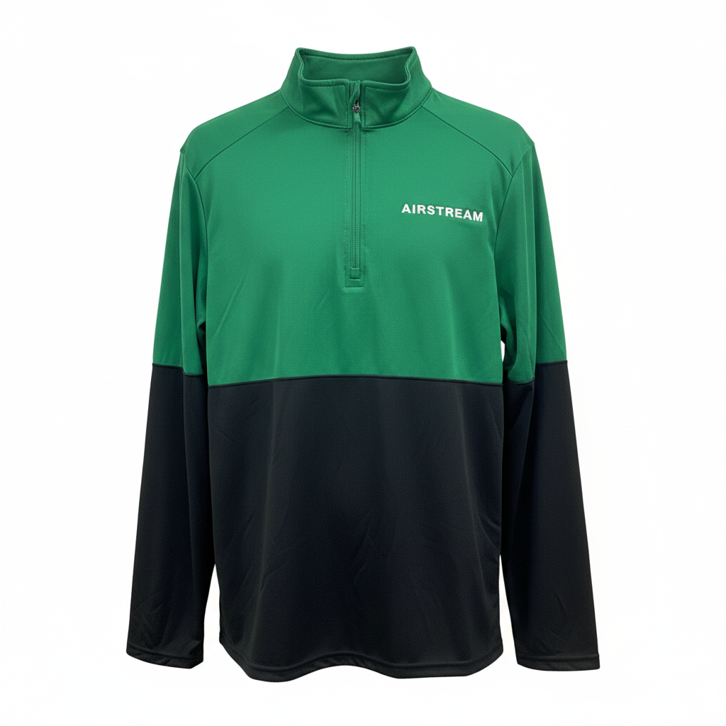 Introducing the Airstream Momentum Performance 1/4 Zip Pullover—a green and black long-sleeve, moisture-wicking quarter-zip featuring “AIRSTREAM” printed on the left chest. This pullover provides UPF 45+ protection to keep you comfortable and protected on all your adventures.