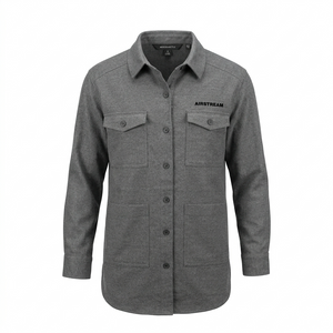 The Airstream Women’s Long Sleeve Twill Overshirt is a gray button-up shirt featuring long sleeves, two chest pockets with flaps, two lower front pockets, and “AIRSTREAM” text on the left chest. Designed as a versatile travel overshirt, it combines style and functionality. The shirt is displayed on a white background.
