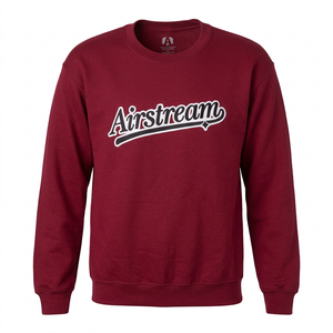 The Pursuit of Airstream Sweatshirt is a maroon crewneck for adventure seekers featuring the word Airstream in a white script font across the chest.