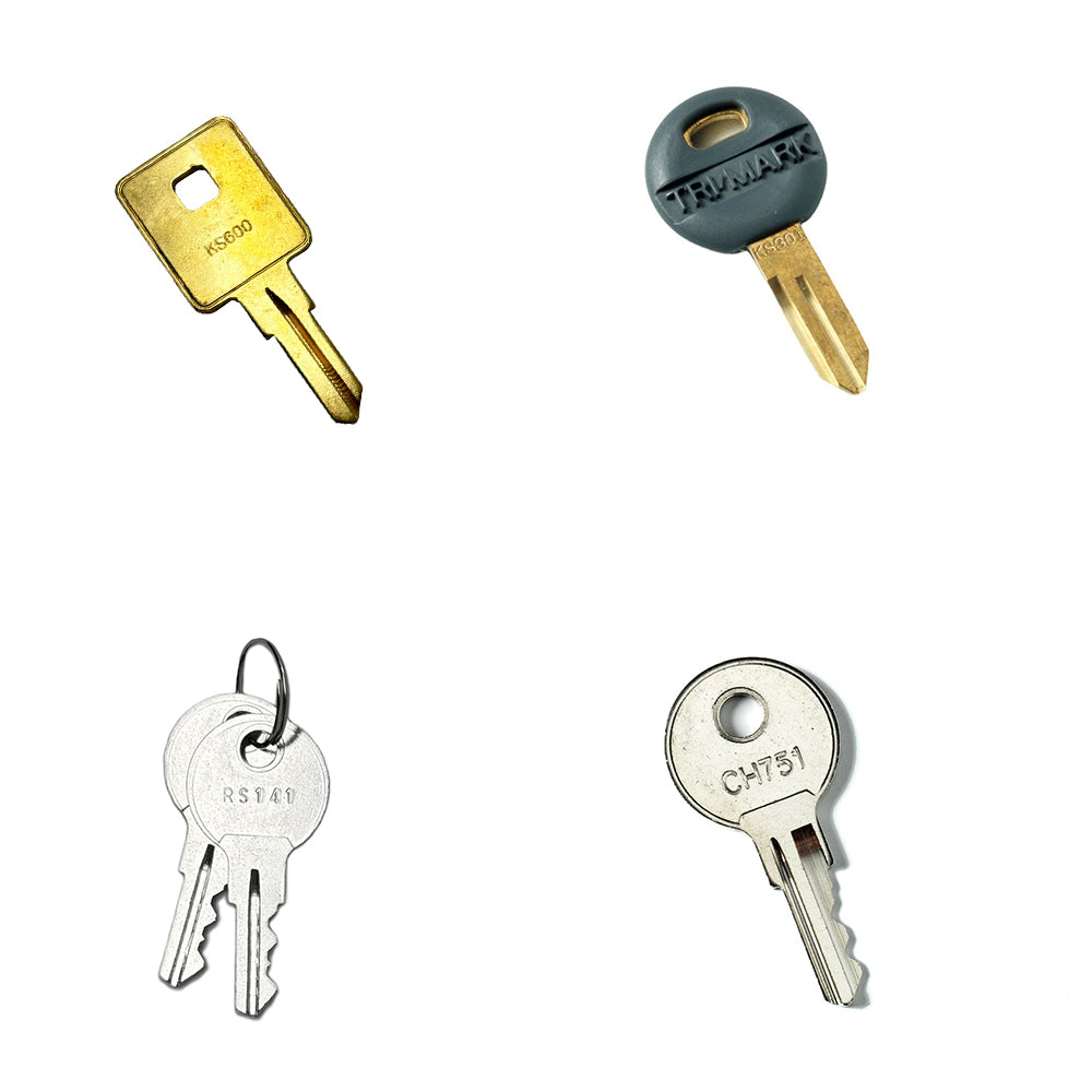 Four distinct keys from the Airstream Cut Key Bundle for Eddie Bauer Travel Trailers are displayed on a white background: a brass key, a key with a gray plastic head, two silver keys on a ring, and a round silver key labeled CH751—perfect as pre-cut trailer or spare keys for Airstream Eddie Bauer models.