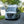 Mercedes-Benz camper van on a road with trees and water in the background