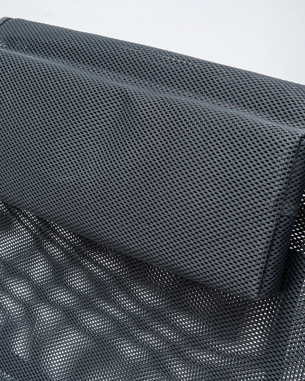 Close-up of a dark gray mesh fabric product, showing the detailed woven texture and folded structure against a light gray background.