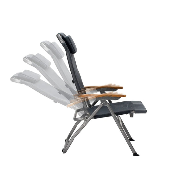 A folding outdoor lounge chair with a black padded seat and backrest, light brown wooden armrests, and a silver metal frame, shown on a plain white background with a translucent motion-style overlay illustrating the reclining mechanism.