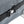 Close-up of a black strap with a buckle on a textured gray surface