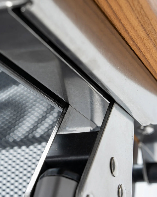 Close-up of a metal bracket with wooden surface and mesh background
