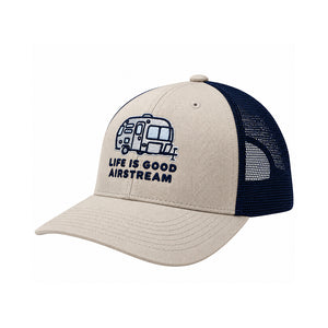 The Airstream Colorblock Camper Hat by Life is Good® features a tan and navy blue colorblock design with a breathable mesh back. The front showcases an embroidered illustration of an Airstream trailer along with the words “LIFE IS GOOD AIRSTREAM” in blue, making it the ideal camper hat for every adventure on the open road.